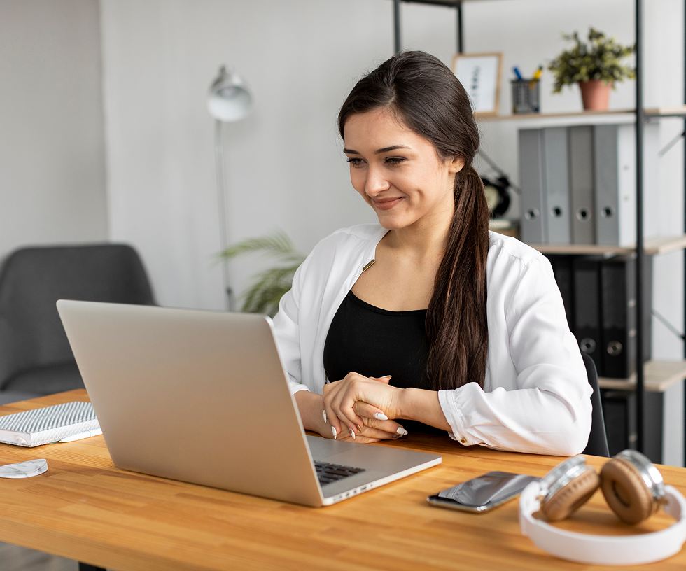 Team member smiling at laptop with word cloud UI